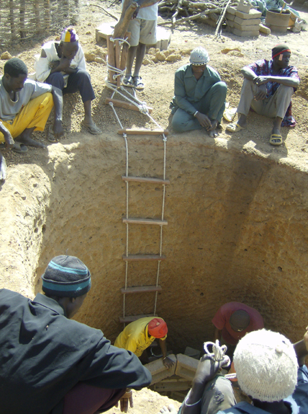 Laying the bricks to line the village chief's well